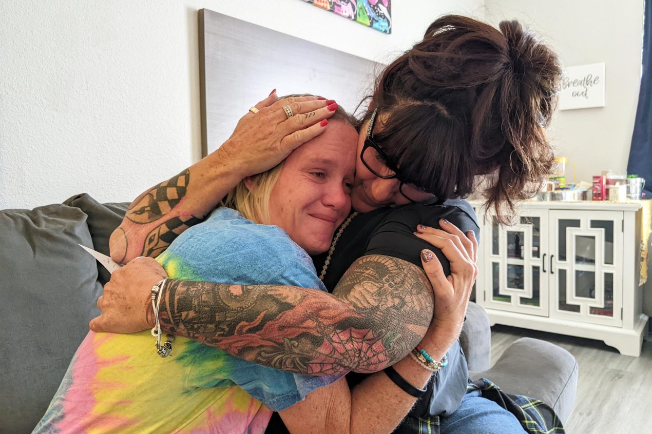 A photo shows Donna Norton hugging Sarah Wright.