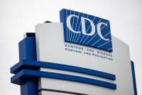 A photo shows a sign with the Centers for Disease Control's logo.