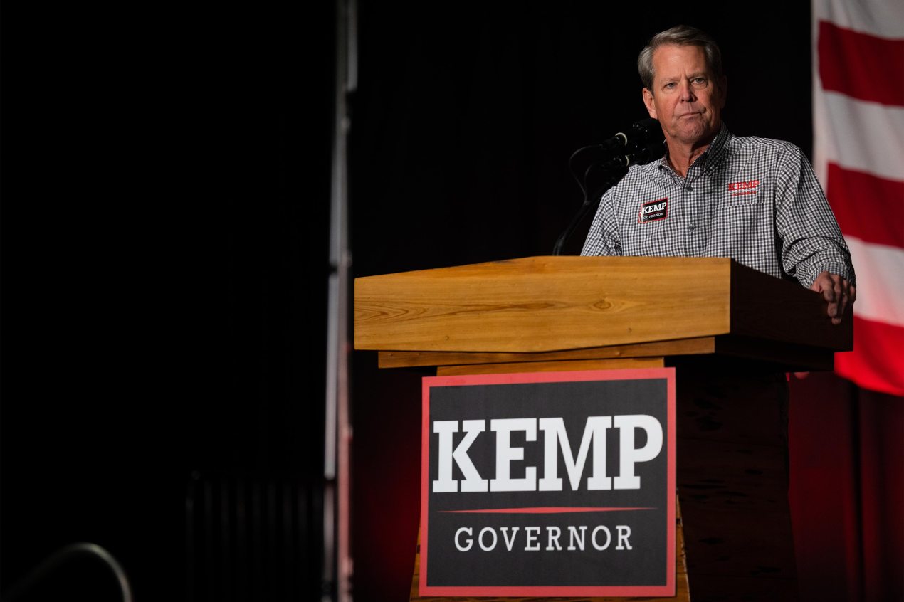A photo shows Gov. Brian Kemp speaking at a rally.