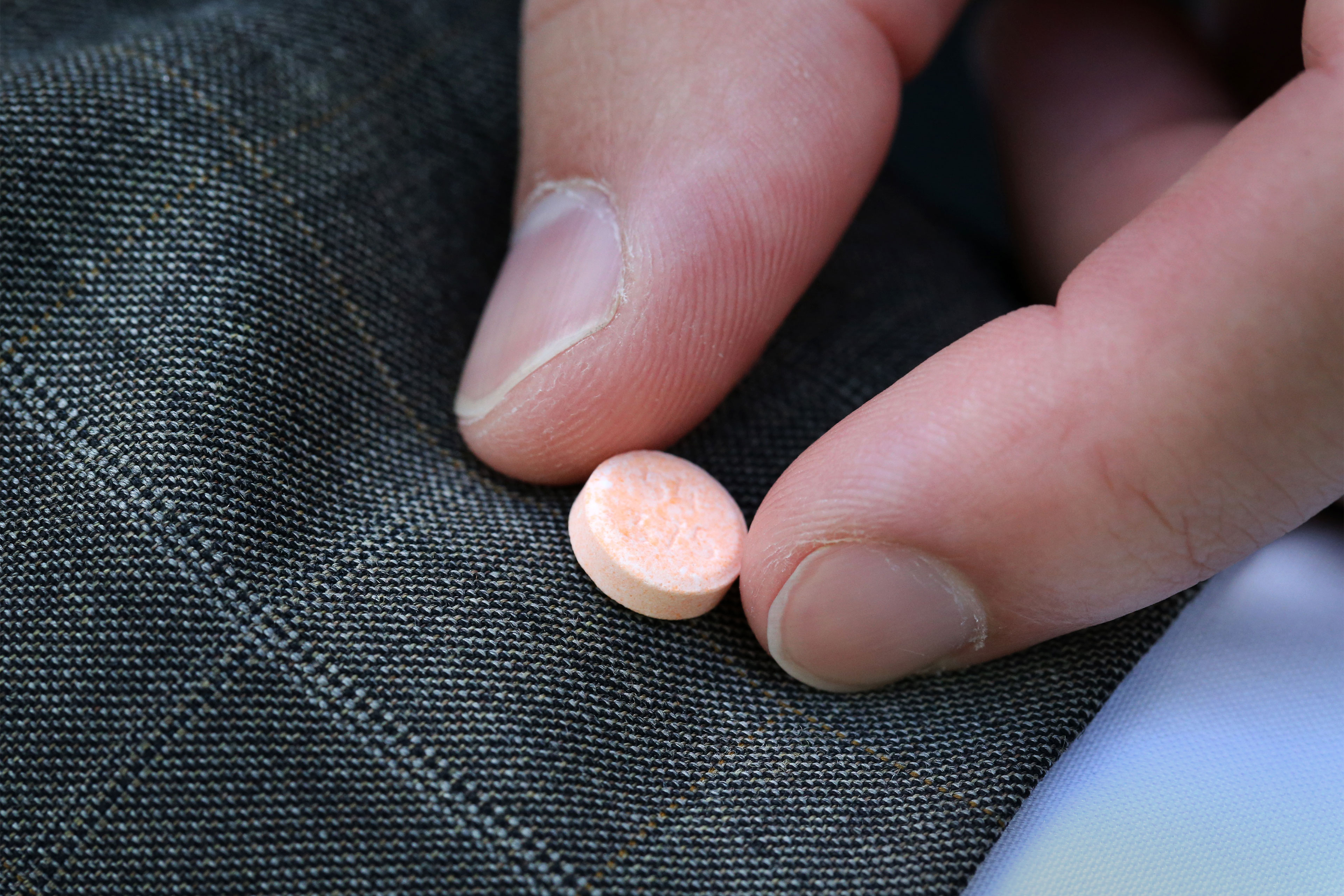 A photo shows someone holding a Suboxone tablet.