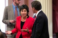 A photo shows Susan Talamantes Eggman, a California state senator, talking to Ted Gaines, a former state senator.
