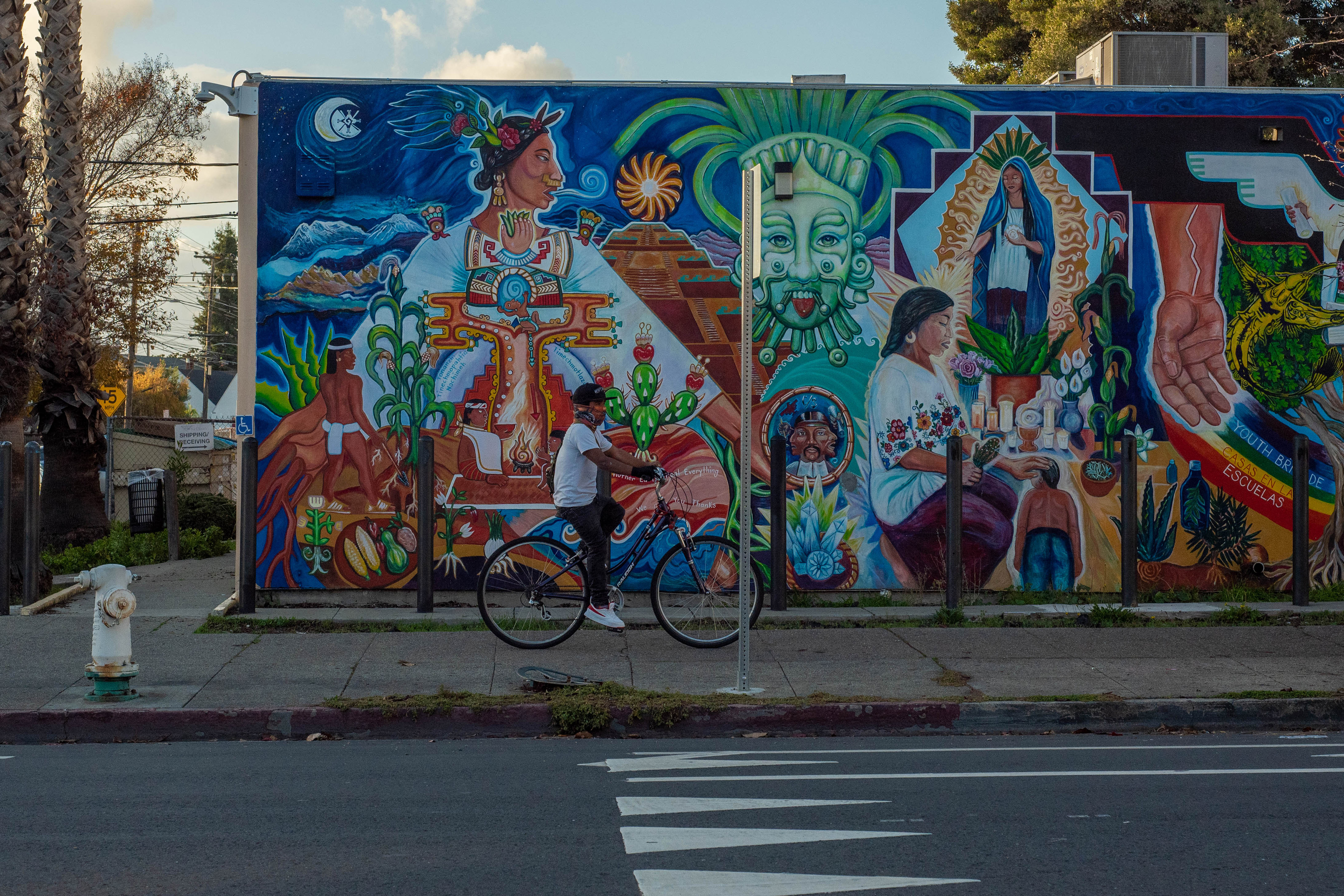 A photograph of a large, colorful mural on the side of a building.