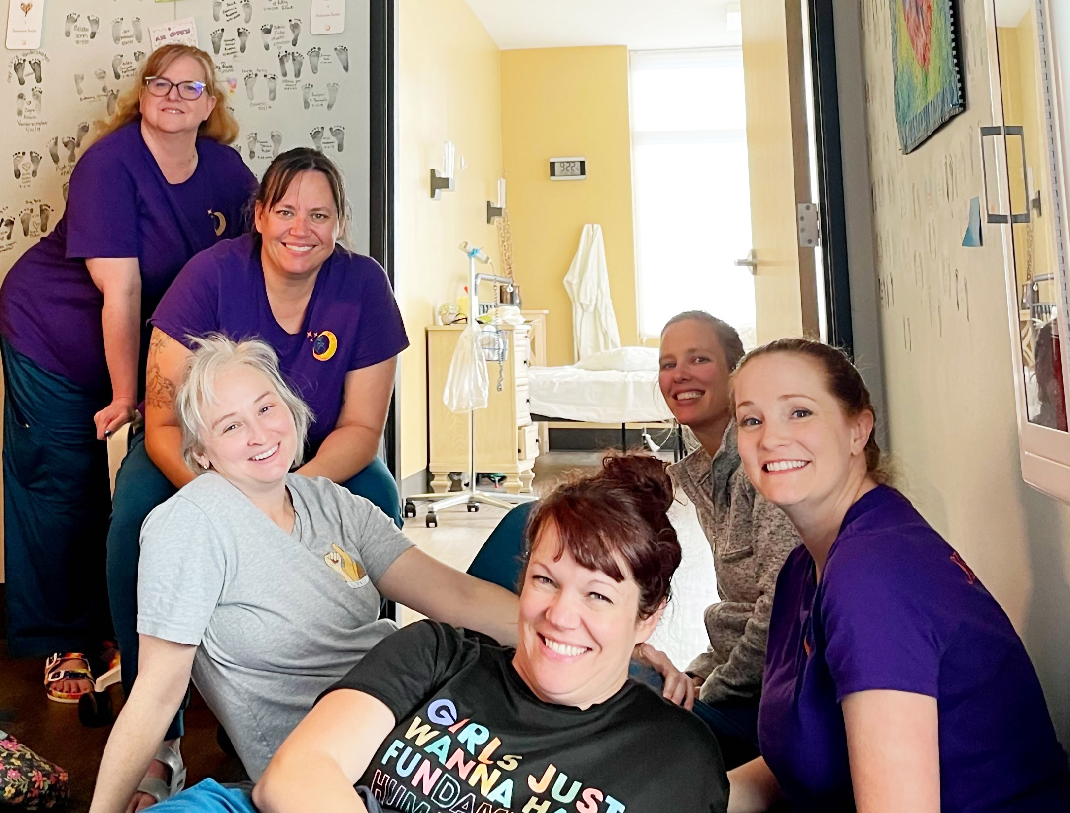 A photo shows workers at Seasons Community Birth Center.
