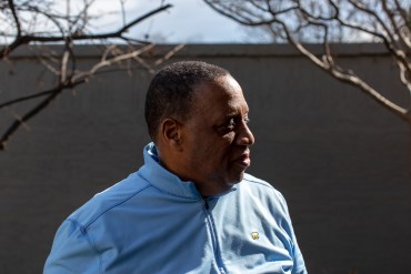 A side profile photograph of Ovester Armstrong Jr., who is standing outside and highlighted by the sun. He is visible from the shoulders up.