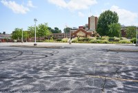 A photo of a hospital and its parking lot.