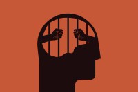 An illustration shows a prisoner behind bars inside of the silhoutte of a man's head.
