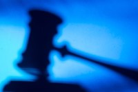 A blurred silhouette of a gavel.
