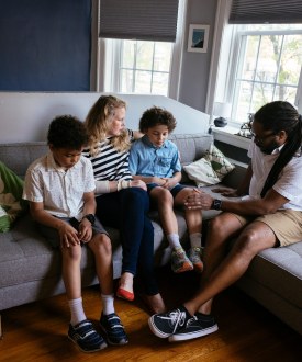 A family sitting together on a couch.