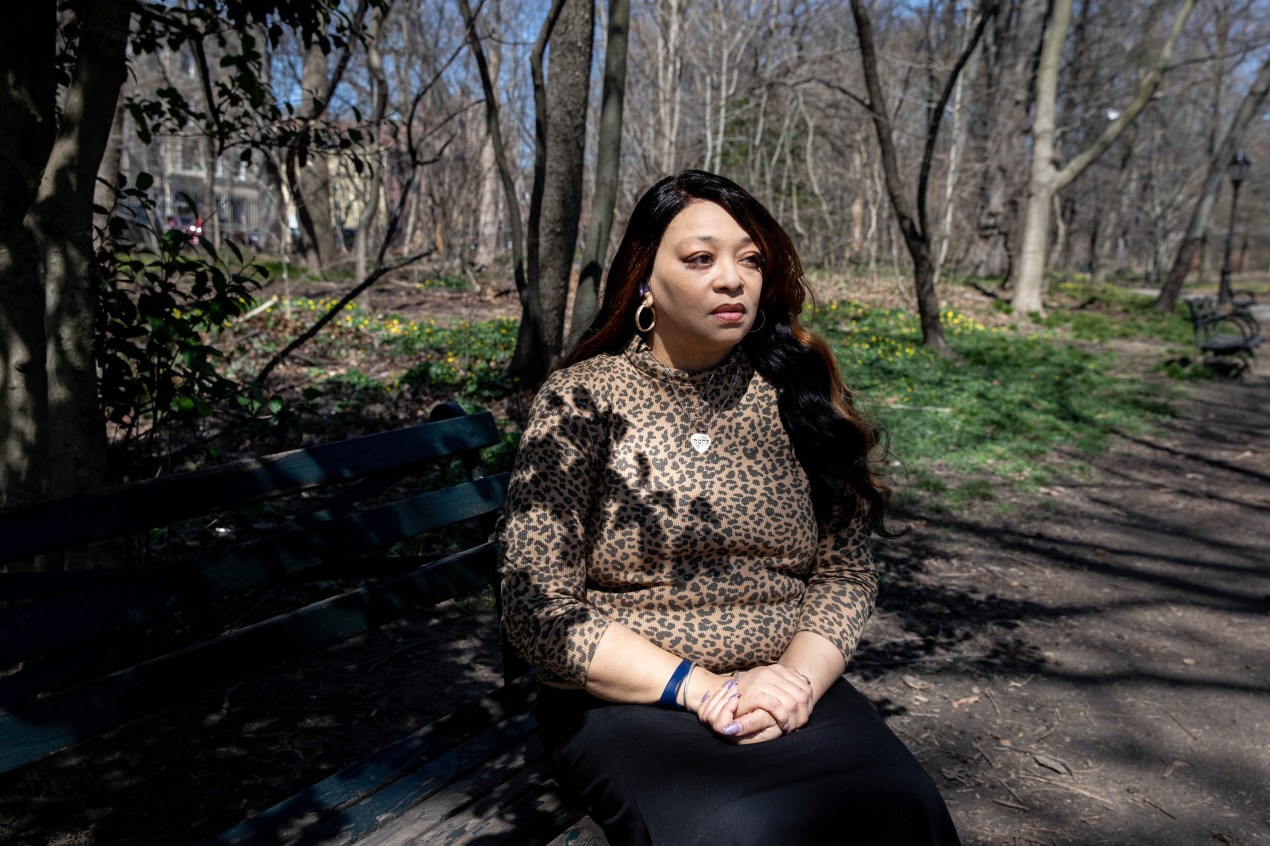 A photo of a woman sitting for a portrait outside.