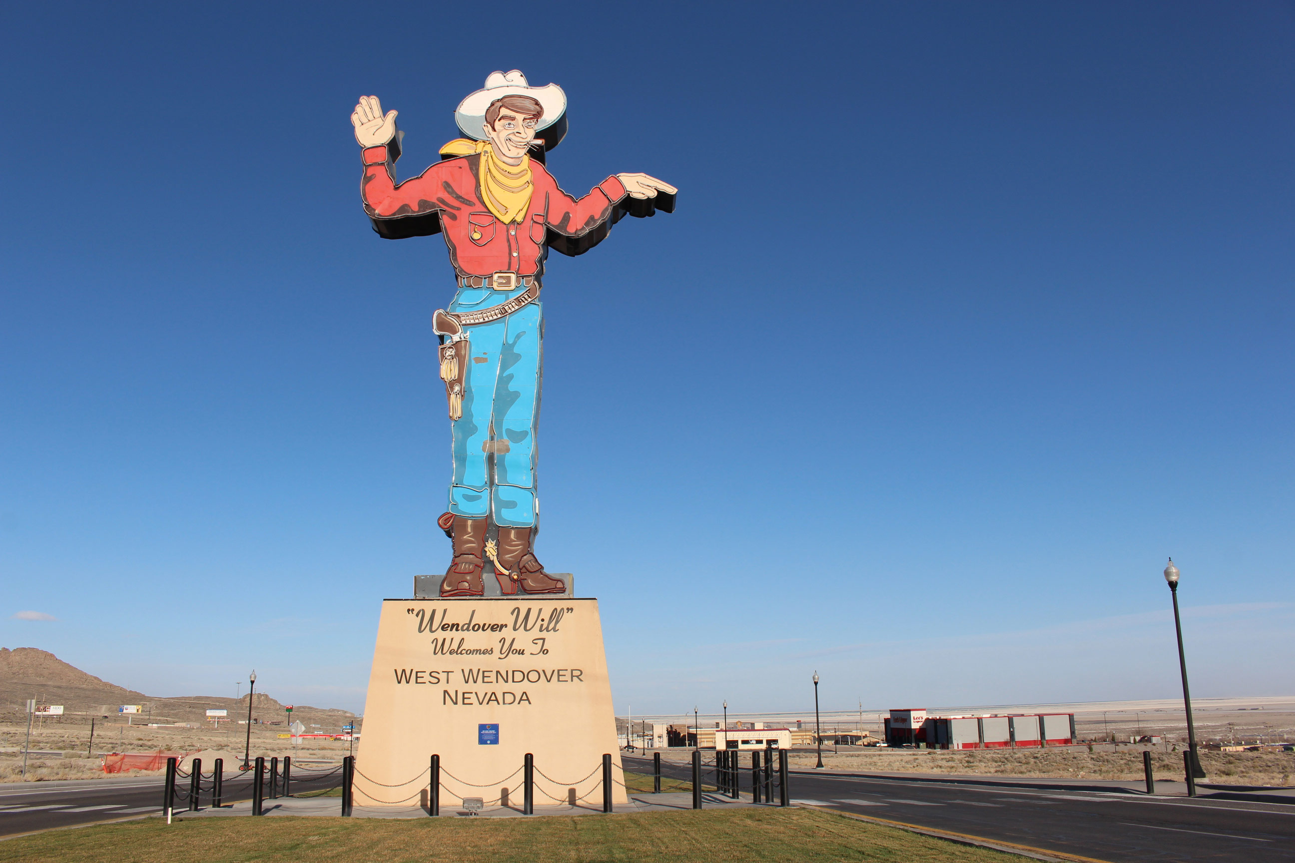 A photo of a large visitor sign depicting a cowboy with text that reads, "Wendover Will welcomes you to West Wendover, Nevada."