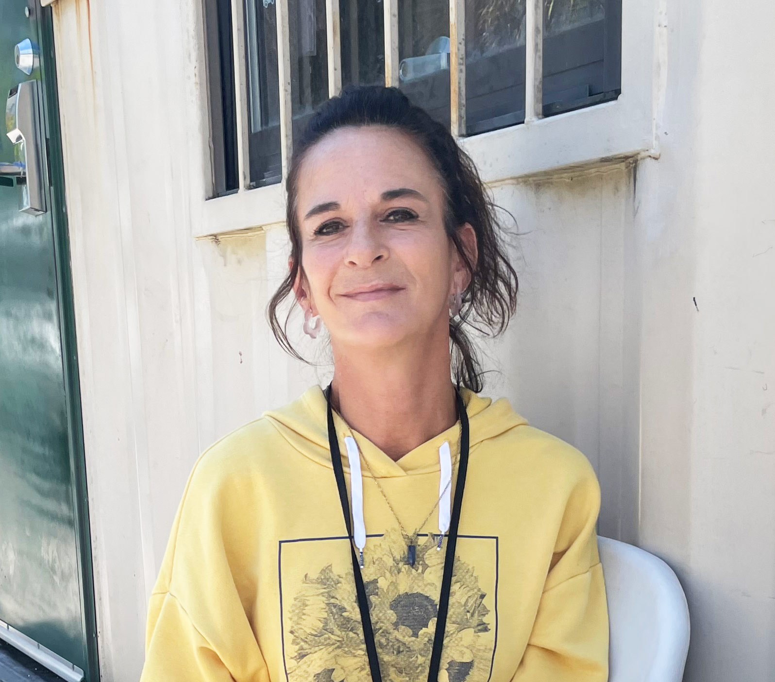 A photo of a woman sitting outside