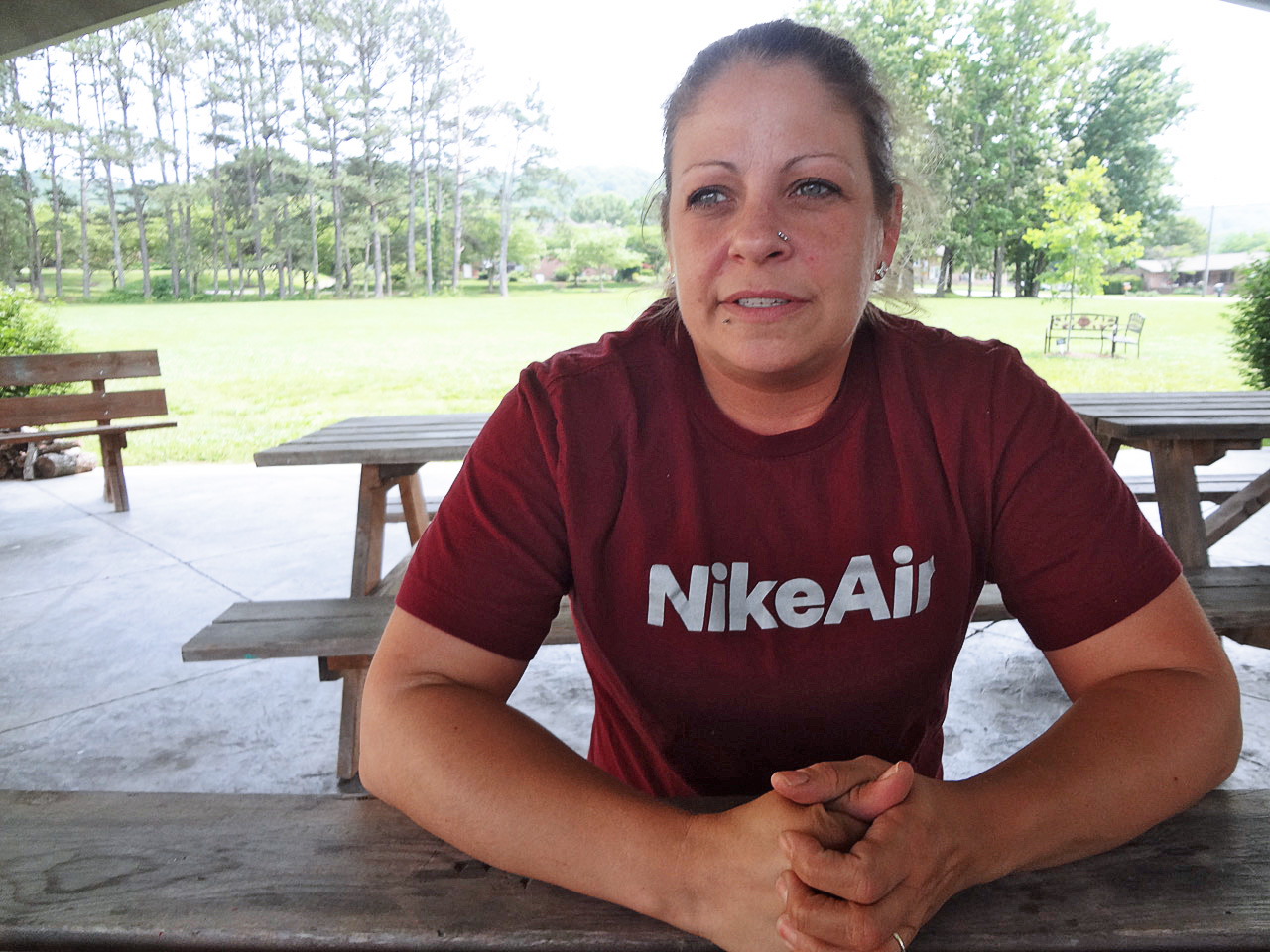 A photo of Rachel Solomon sitting at a picnic table outside.