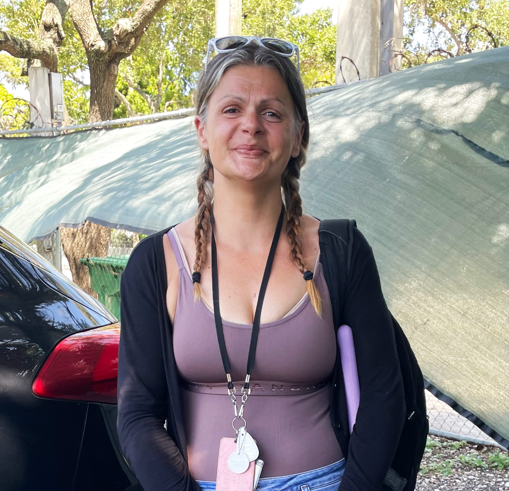 A photo of a woman standing outside.