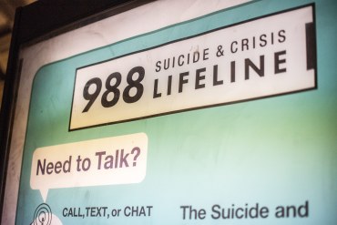A close-up photo of an advertisement for the 988 hotline.