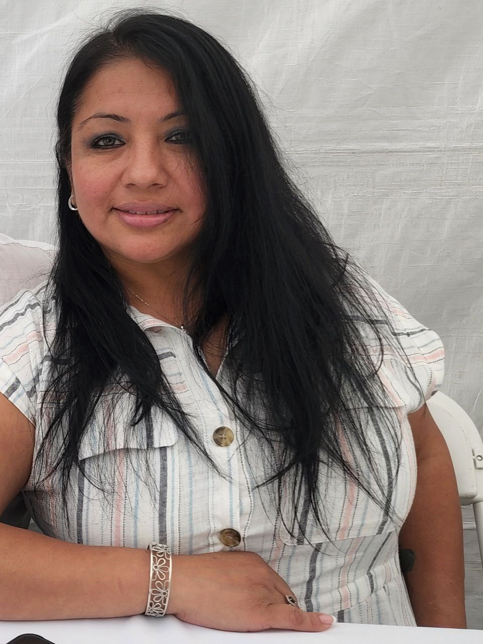 A photo of a woman sitting for a portrait.