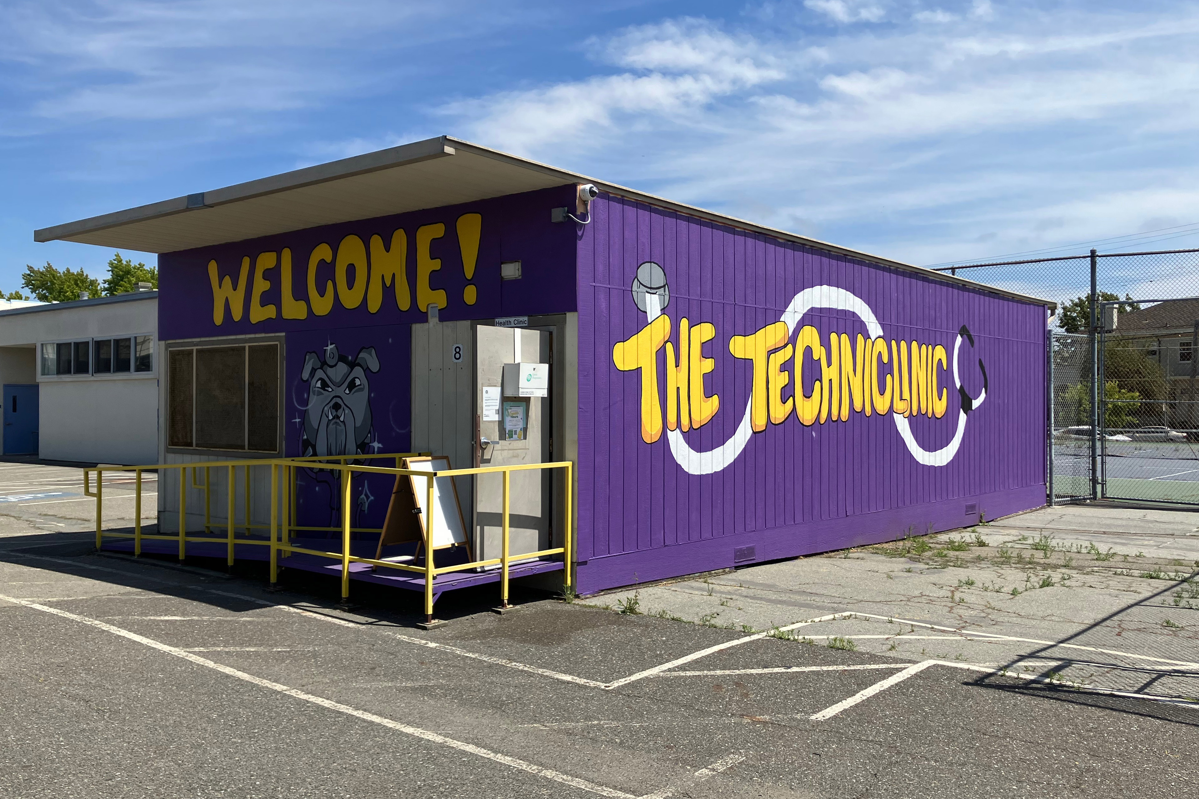 An exterior photo of a clinic painted purple with yellow writing that reads, "The TechniClinic."