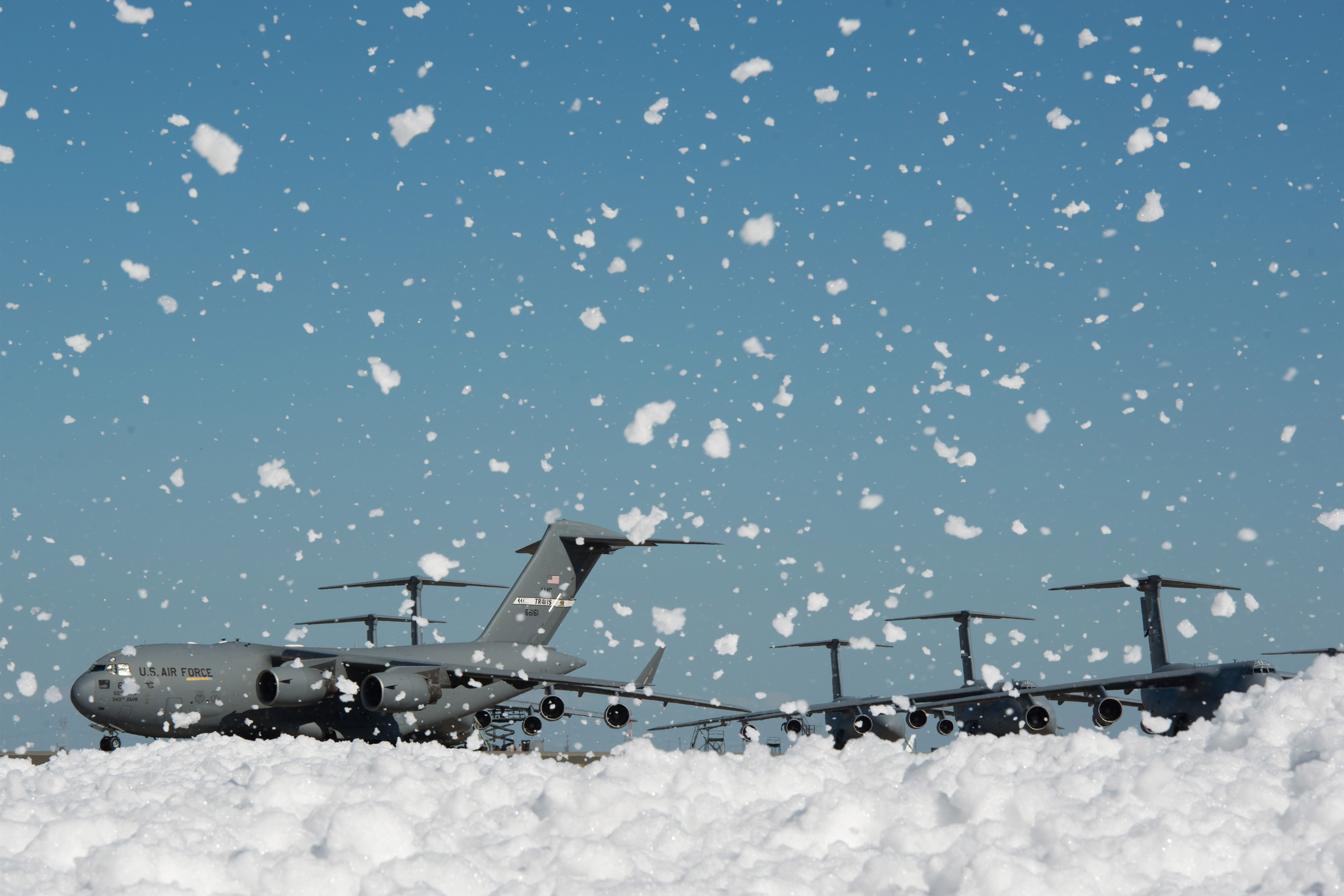 A photo of foam covering Travis Air Force Base's flight line. Military aircraft can be seen in the background.