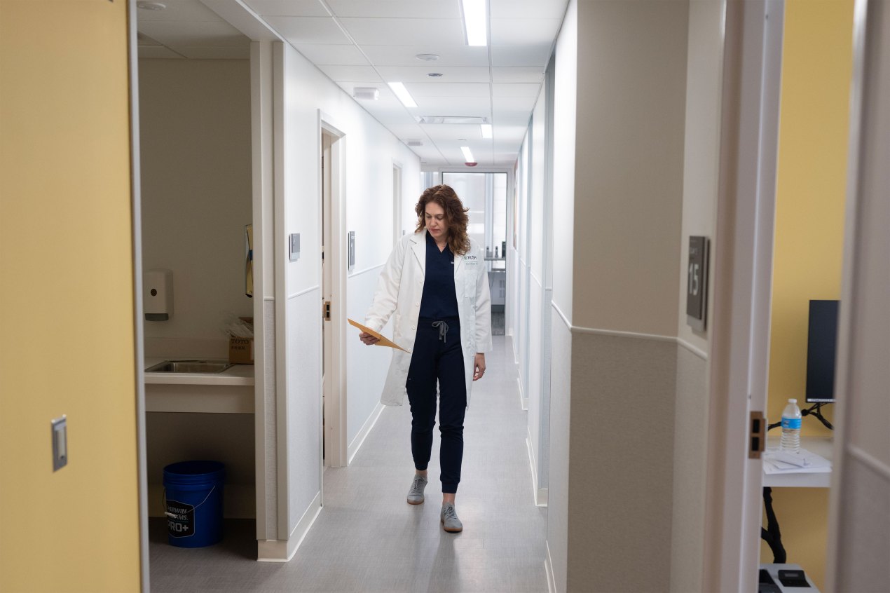 A photo of a doctor walking down a hallway.