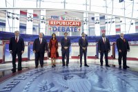 A photo of the seven Republican presidential candidates at the second Republican debate of the 2024 campaign. From left to right, Governor Doug Burgum, former Governor Chris Christie, former Governor Nikki Haley, Governor Ron DeSantis, Vivek Ramaswamy, Senator Tim Scott, and former Vice President Mike Pence.