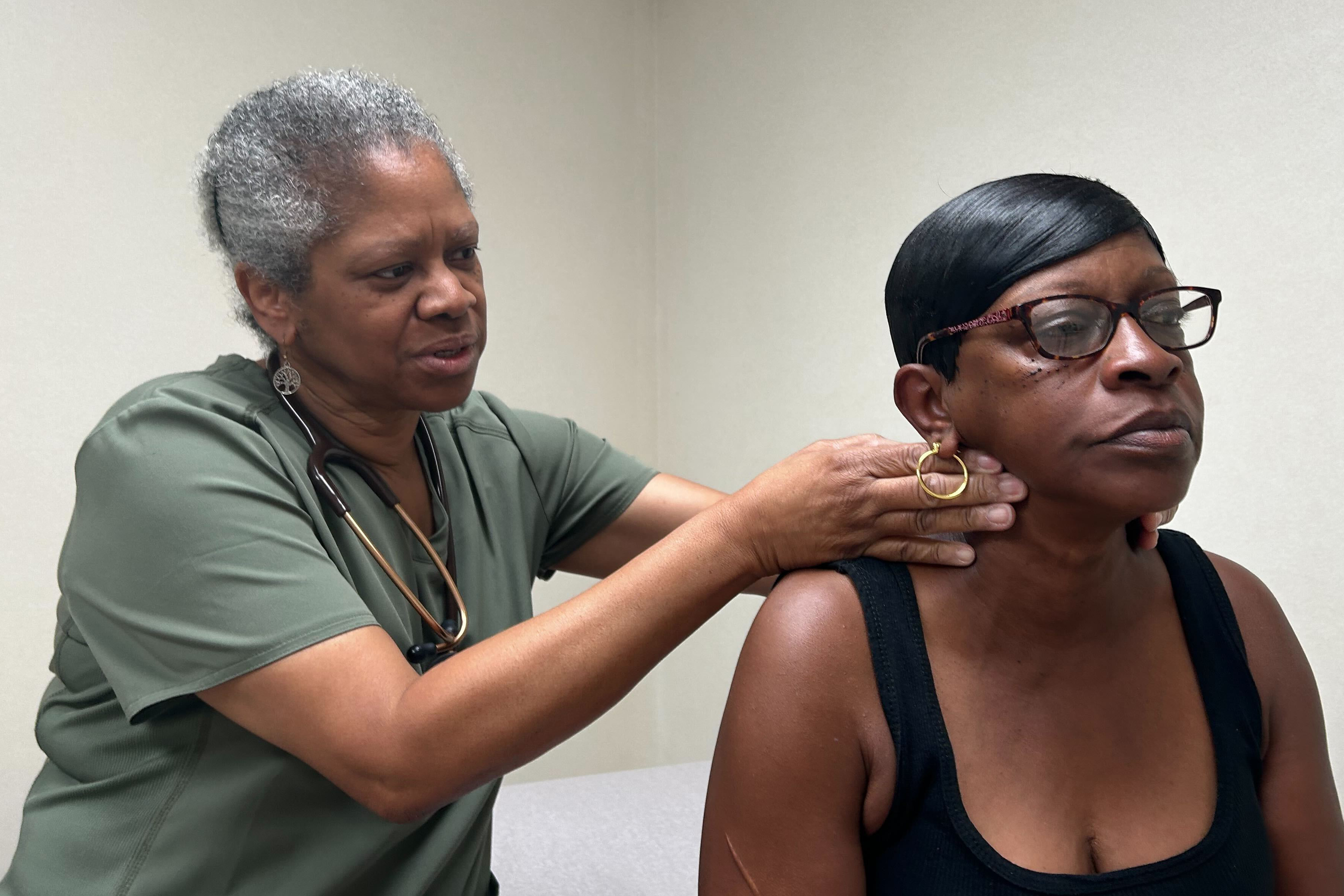 A photo of a doctor examining a patient's throat.