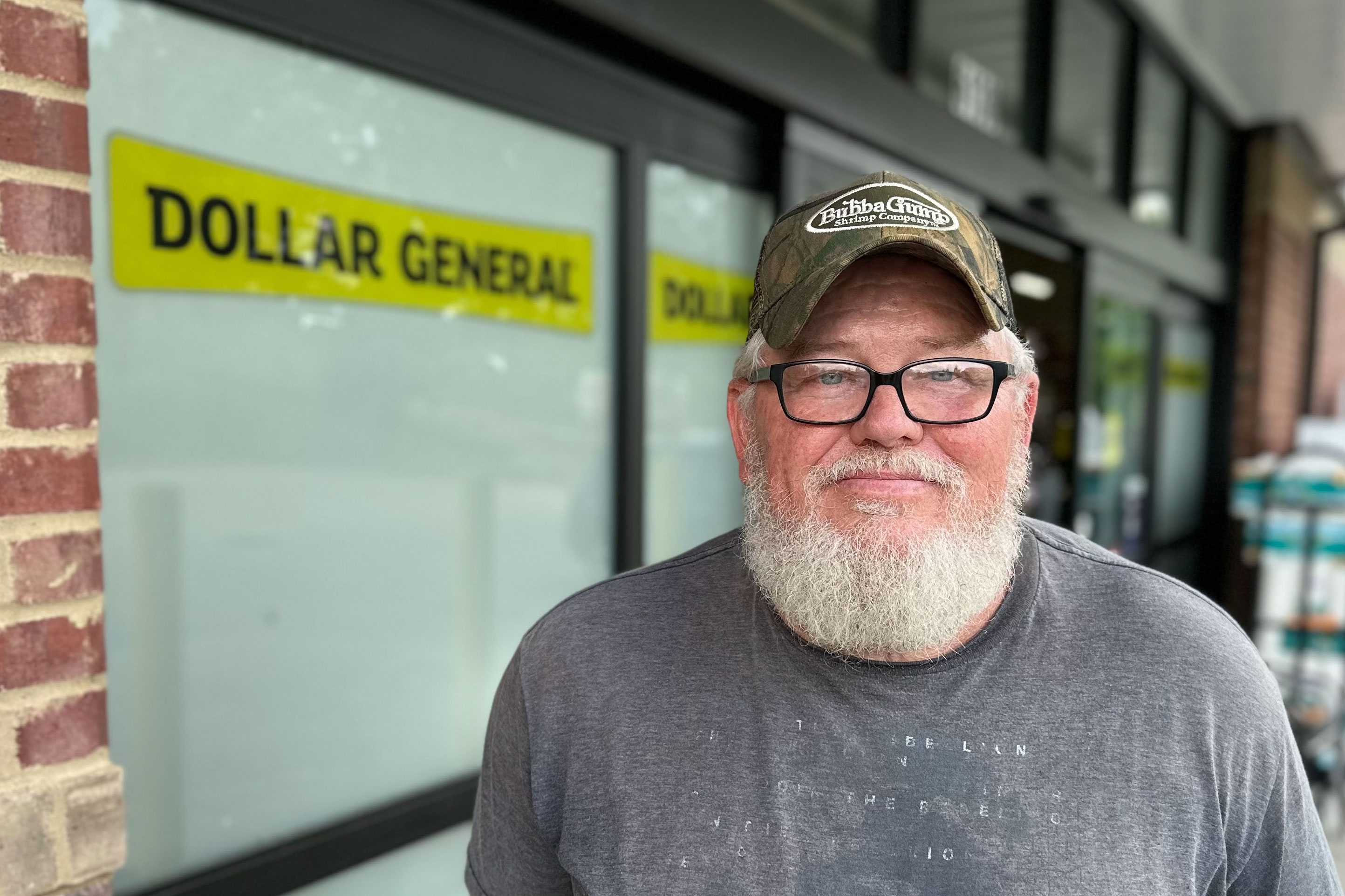 A man standing outside of a Dollar General.