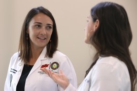 A photo of two medical students talking.