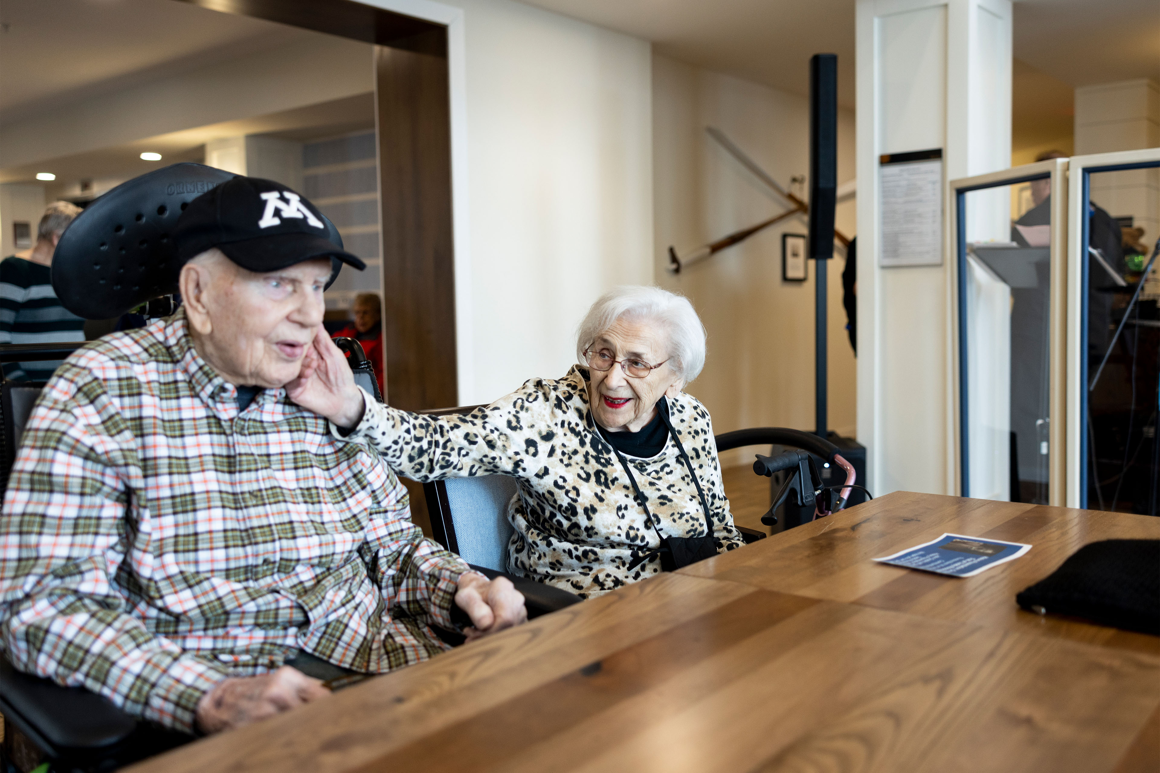 A photo of an elderly couple sitting together at a table.