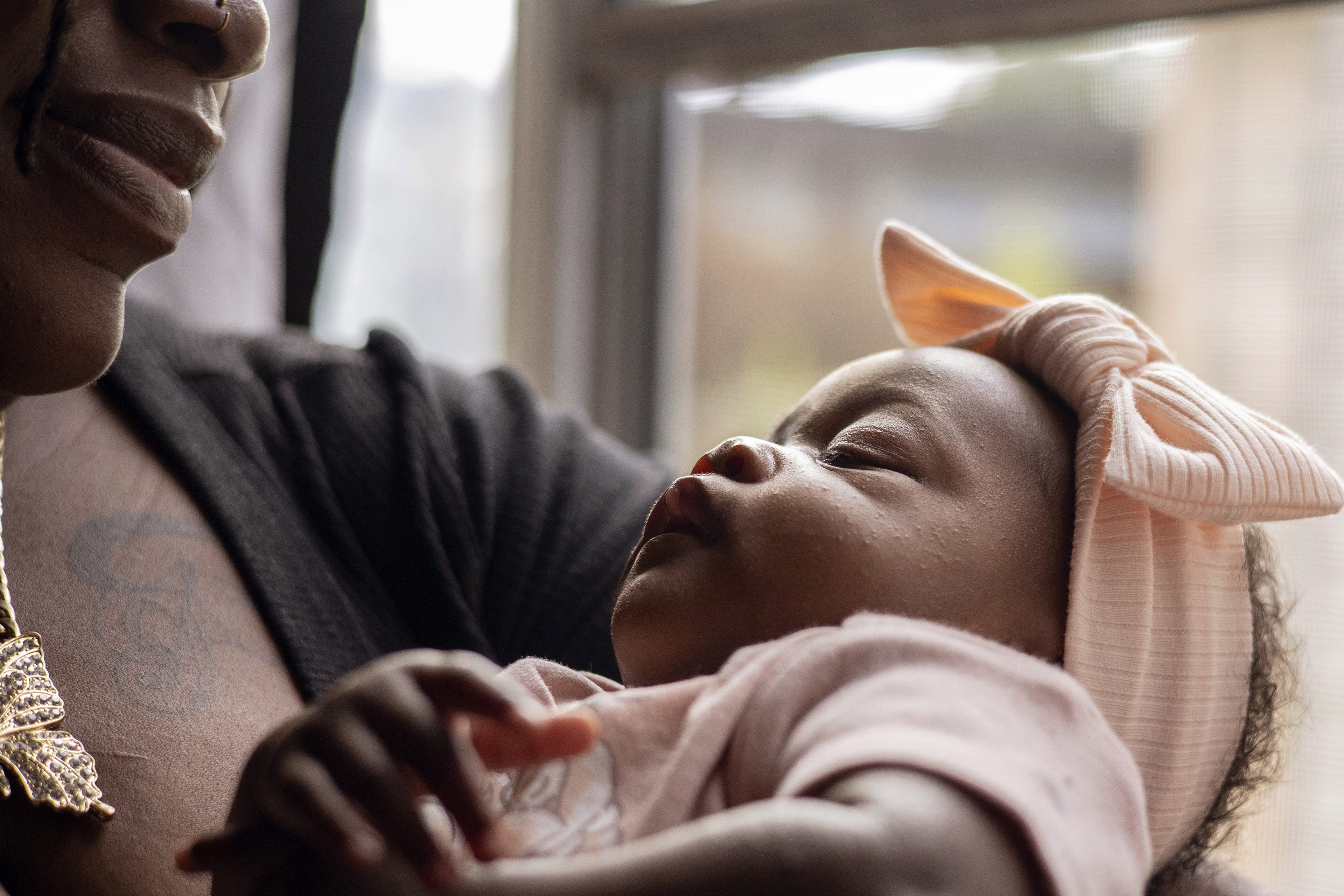 A portrait of infant Journee Davis in her mother's arms.