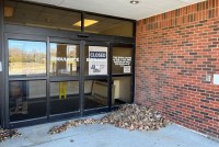 The former ambulance entrance at the Keokuk Area Hospital has a large sign that says "closed" taped to the inside of the automatic doors.