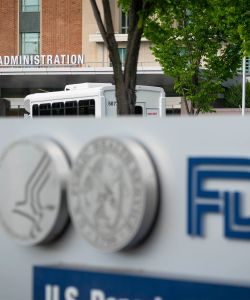A photo of a sign with the FDA's logo in front of its headquarters.