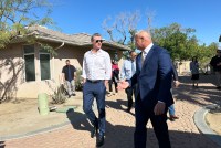 Gov. Gavin Newsom tours ABC Recovery Center in Indio, California, on March 1 with Chris Yingling, its CEO. It is a sunny day and the sky is a clear, vivid blue.
