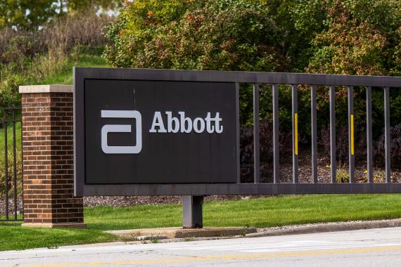 A photo of the Abbott logo on a gate at the company's headquarters.
