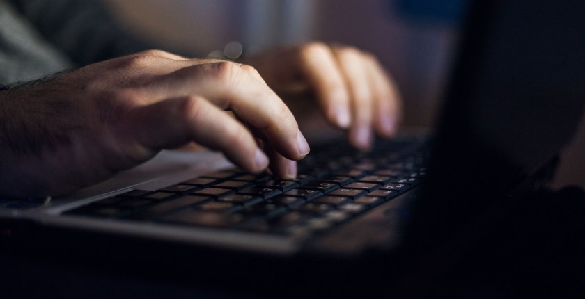 A close-up of shot of an hands typing on a computer keyboard.