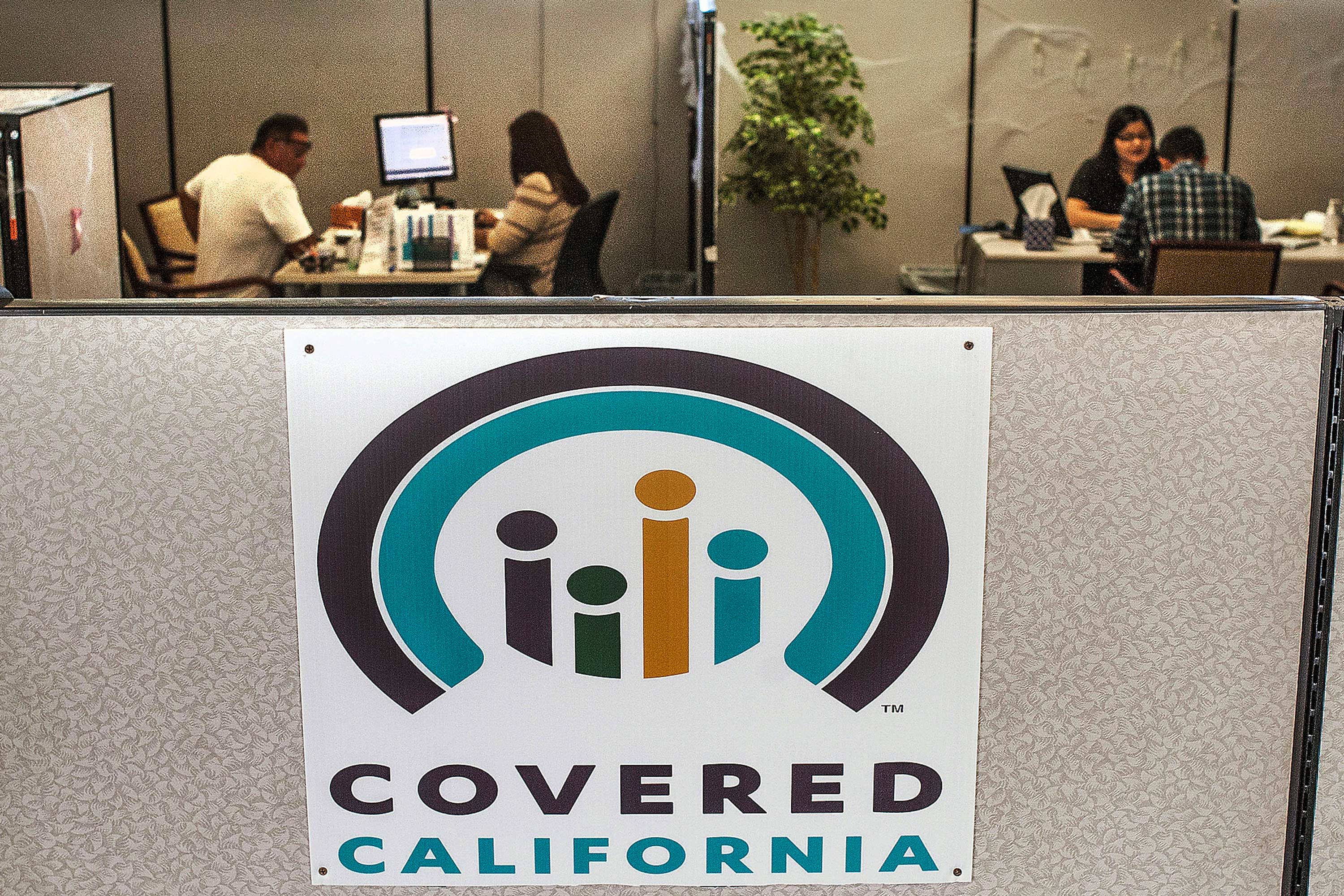 The "Covered California" logo seen on an office cubicle.