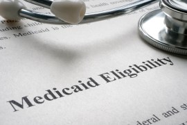 A stethoscope and an information sheet that reads "Medicaid Eligibility"
