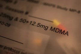 A close-up photo of a packet of pills with the focus text that reads, "12.5 mg MDMA."