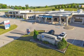 An aerial photo shows the entrance and front parking lot of a hospital.