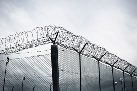 A chain link fence with barbed wire at the top