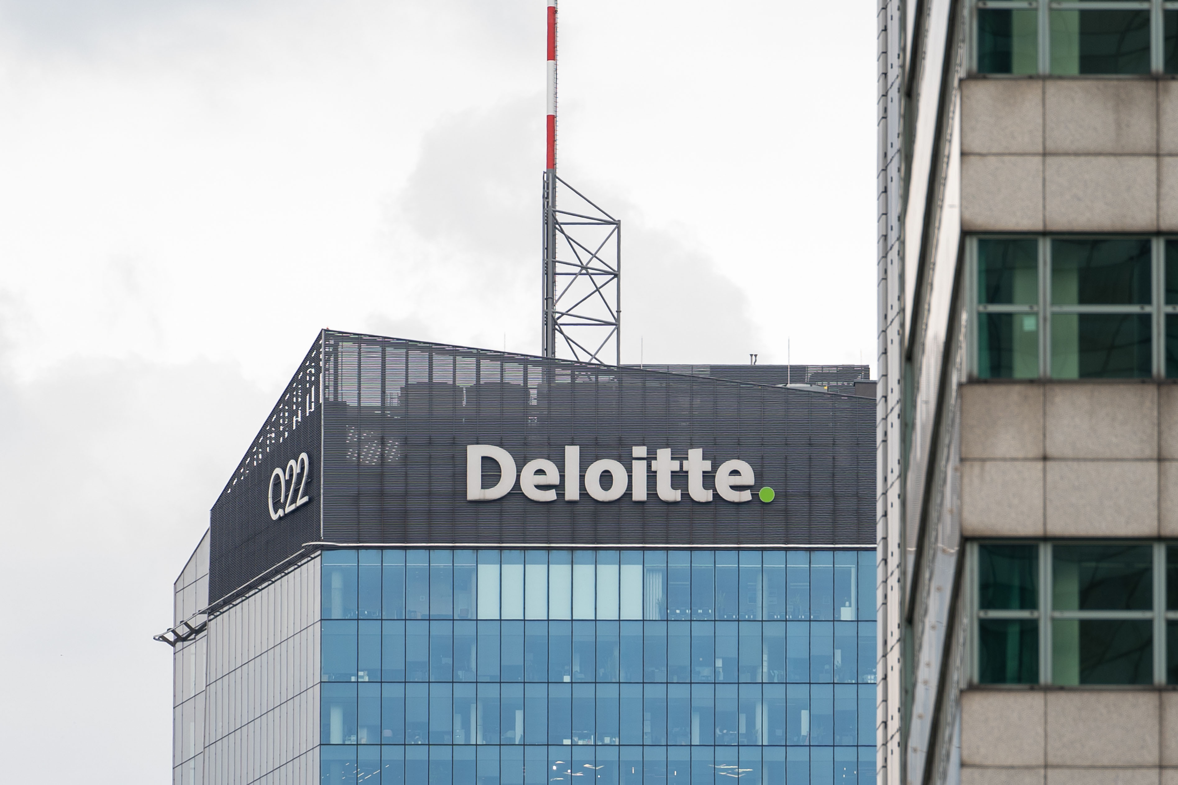 The Deloitte logo is seen on a skyscraper building in Warsaw, Poland.