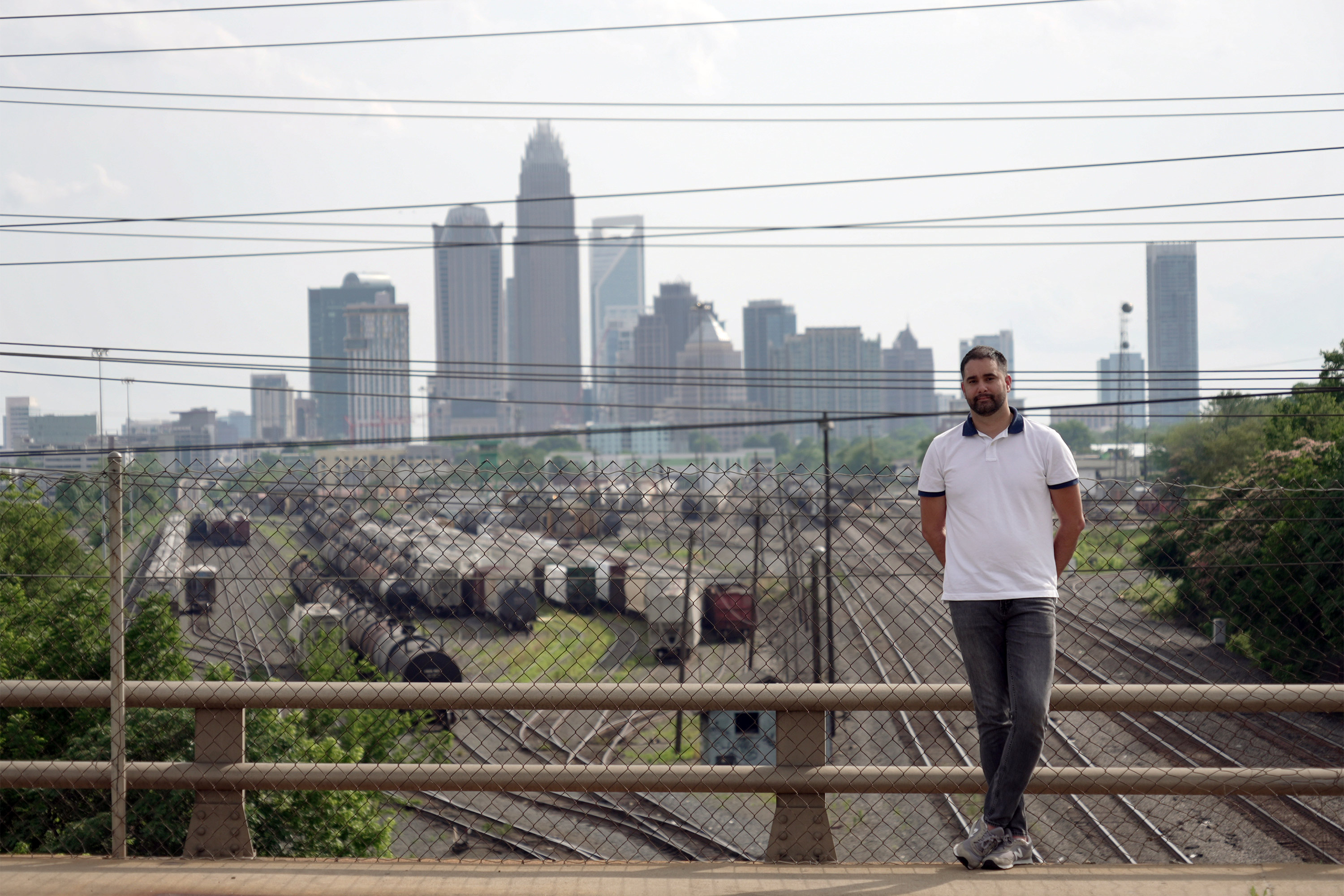 A photo of a man standing at an overpass.