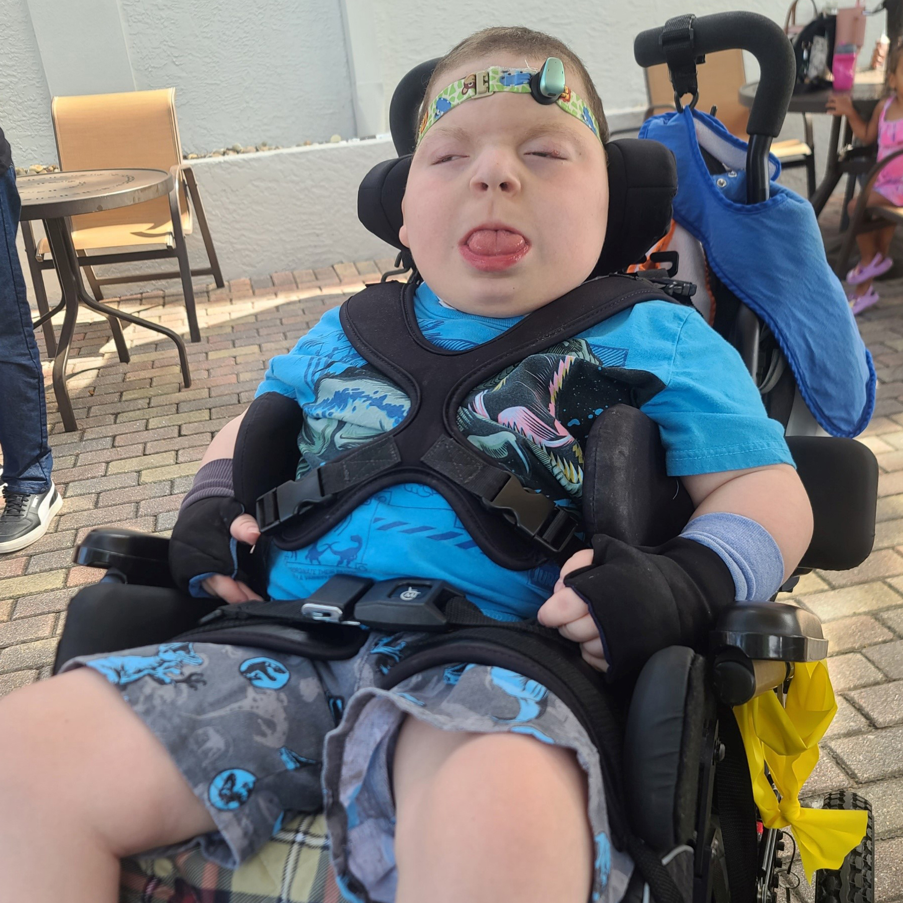 A photo of a young boy in a wheelchair.