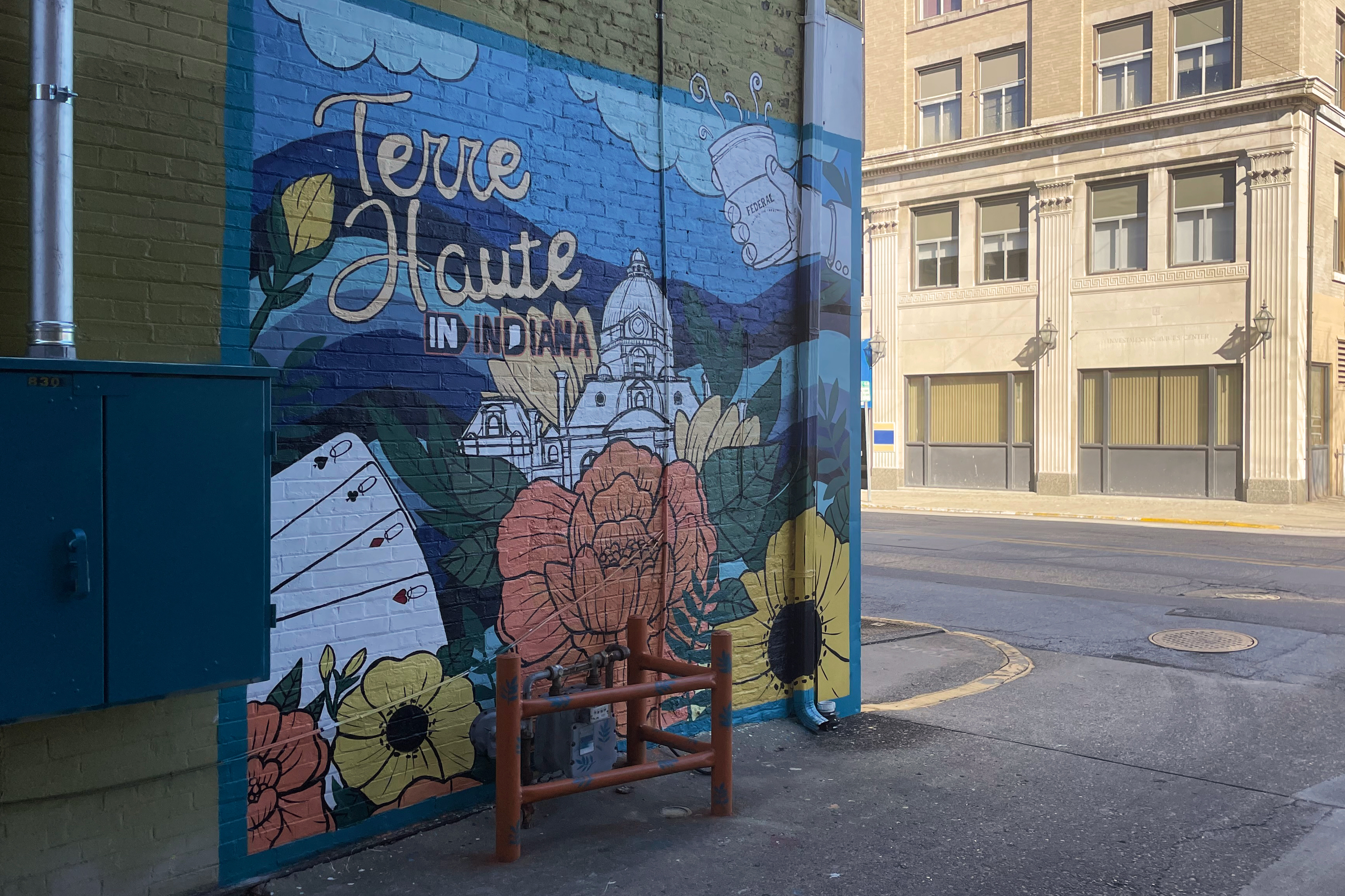 a mural on an outdoor wall that shows flowers and reads Terra Haute, Indiana