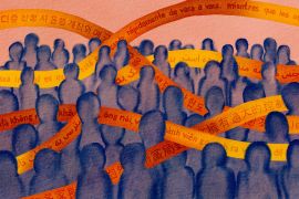 A watercolor illustration that shows a crowd of purple figures surrounded by orange bands of text weaving between them. The text is in various languages, including Spanish, Korean, and Vietnamese.