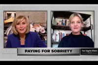 A screenshot from a TV segment where a TV presenter is interviewing a reporter via video call. Text on the screen reads, "Paying for sobriety."