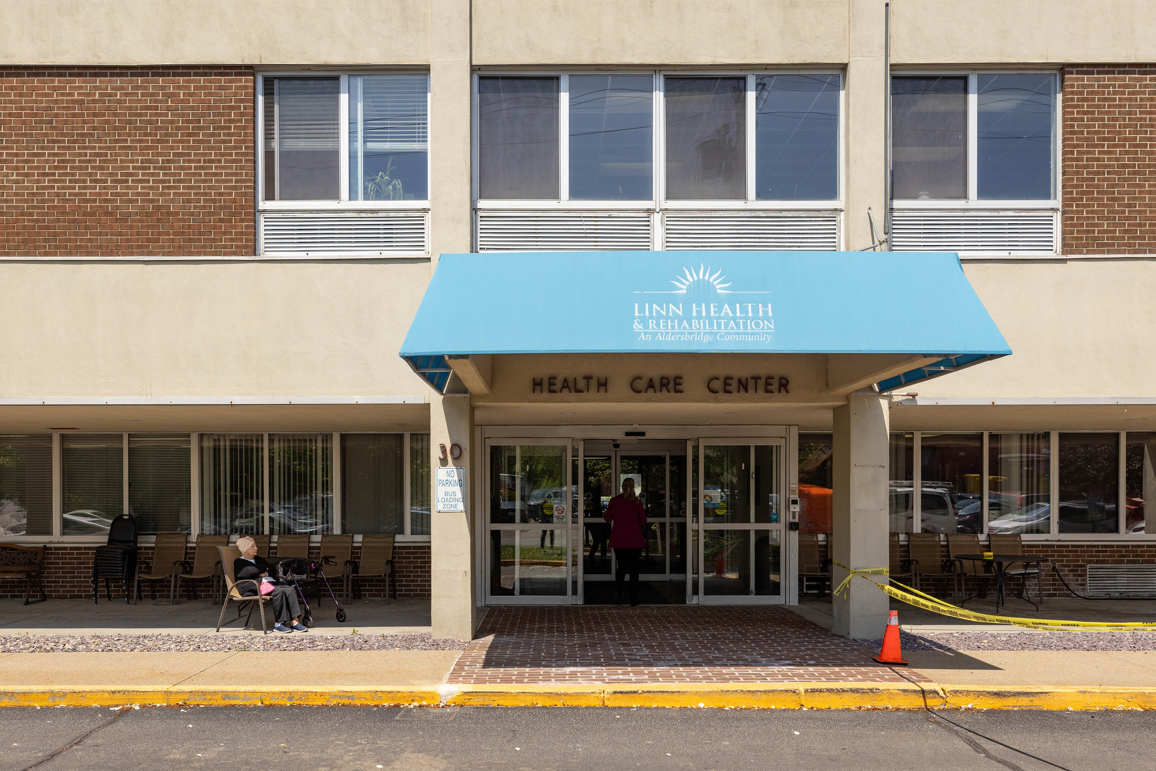 A blue awning covers the entrance to Linn Health & Rehabilitation in East Providence, Rhode Island