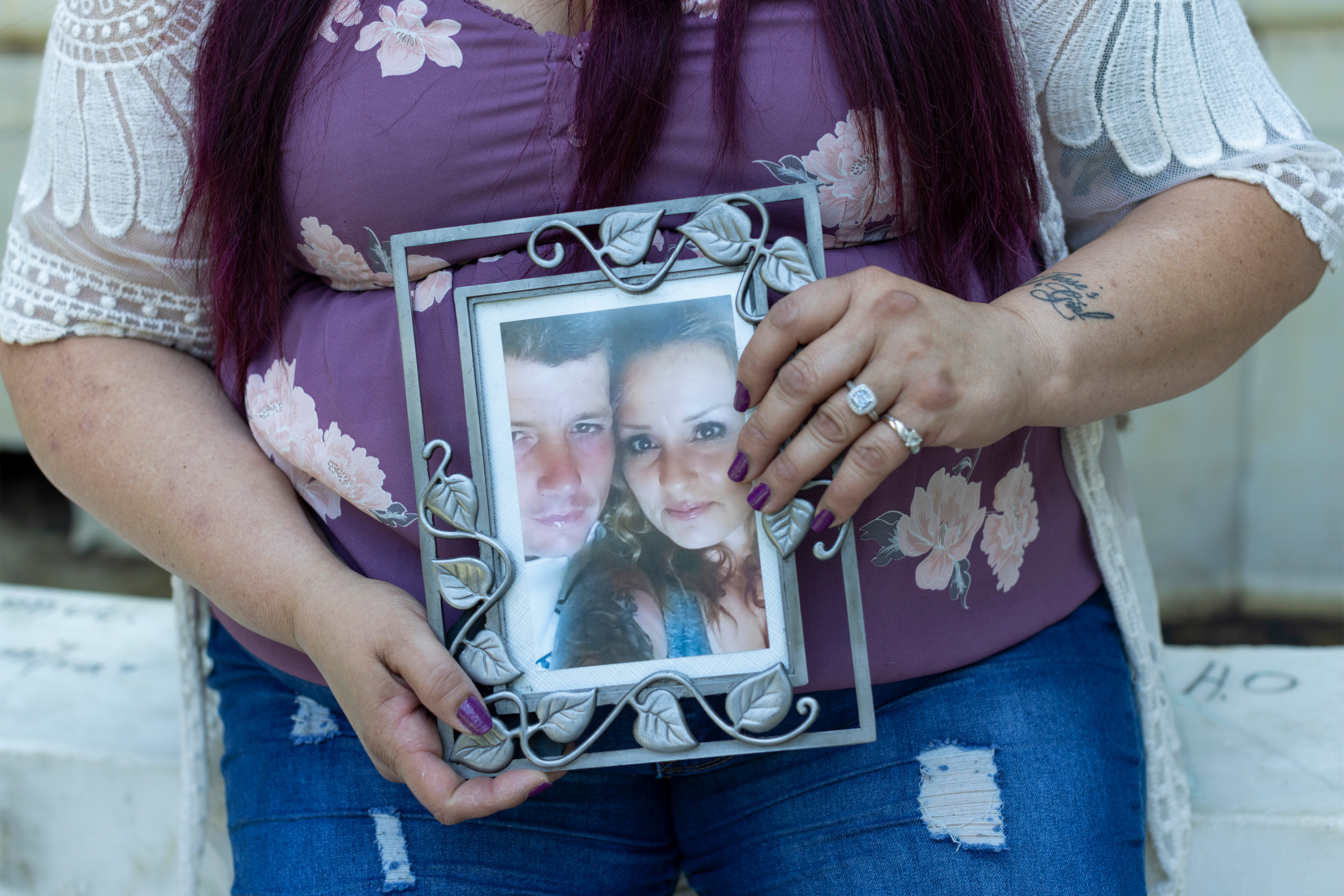 A photo of Sonja Verdugo's hands holding a framed picture of her and her husband.