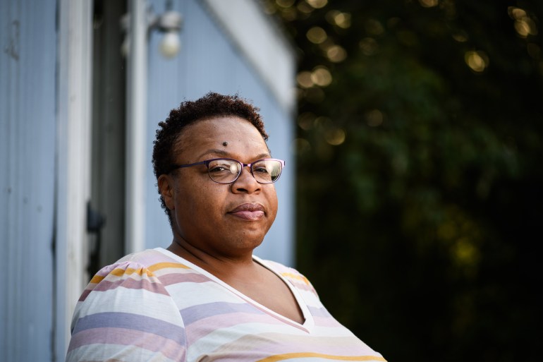 A portrait of Stacey Freeman in front of her home.