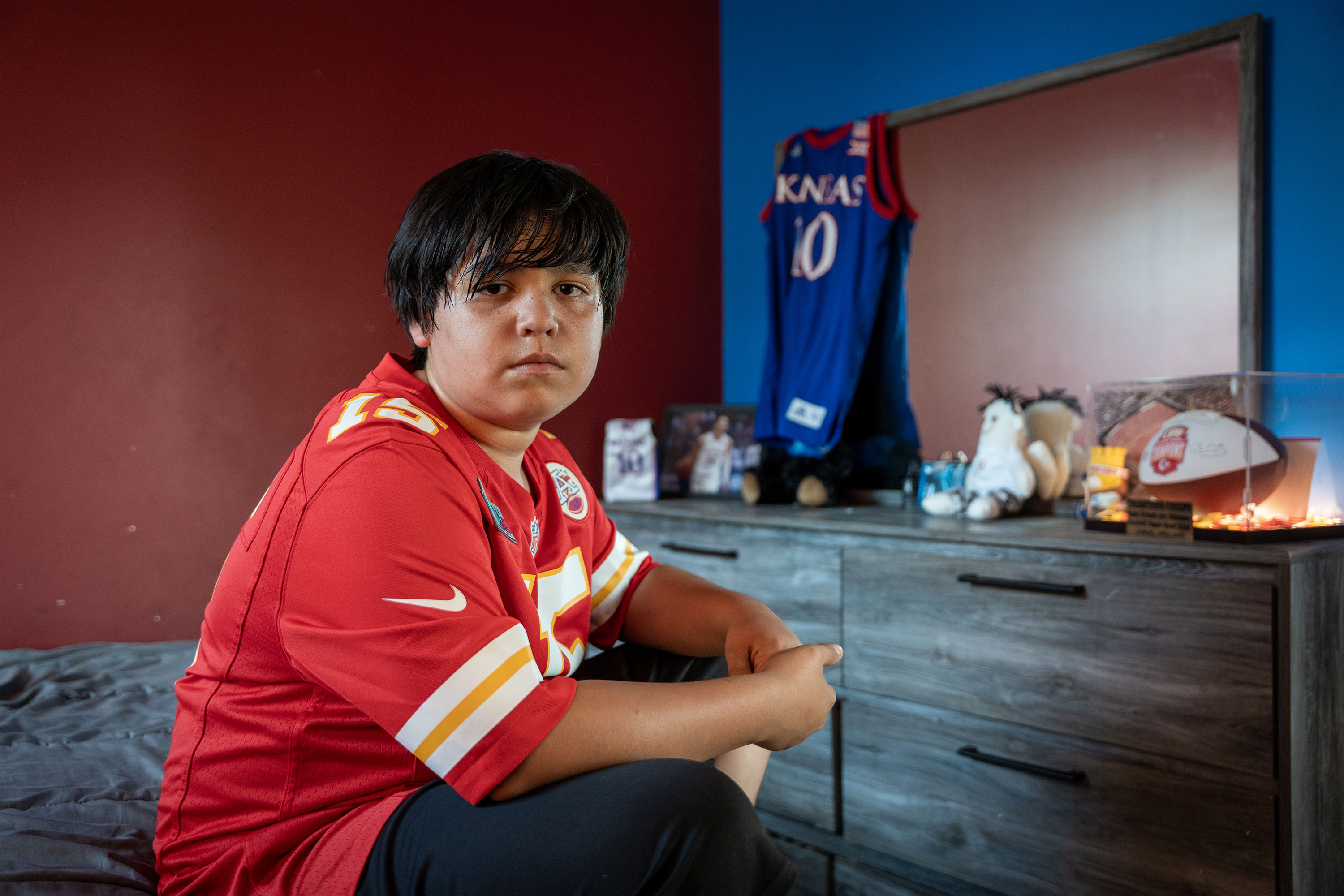 A photo of Samuel Arellano sitting in his room.