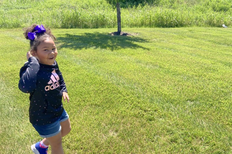 A photo of a young girl playing outside.