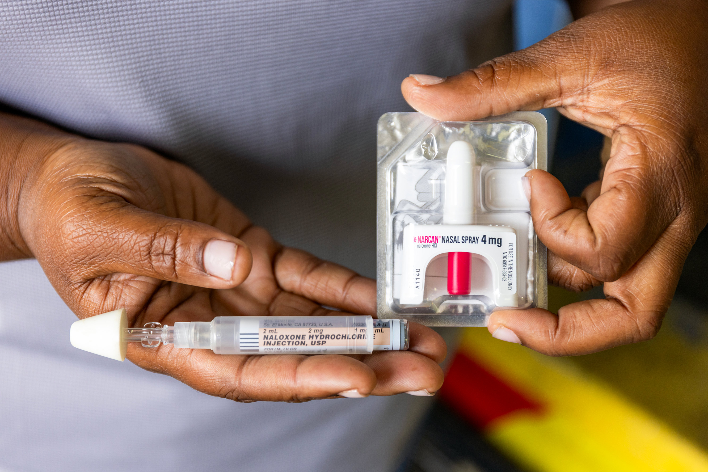 A photo of hands holding naloxone.